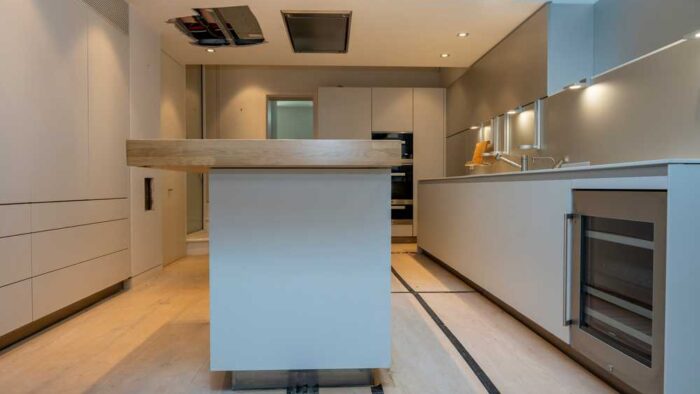 Luxury Bulthaup B3 White Kitchen with Pocket Doors including Large Matching Island with Breakfast Bar- Quooker Appliance – White Quartz Worktops