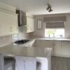 Symphony Crown Brook Ivory Shaker Kitchen with Peninsula – AEG Appliances – Quartz Overlay Worktops