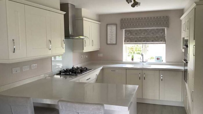 Symphony Crown Brook Ivory Shaker Kitchen with Peninsula – AEG Appliances – Quartz Overlay Worktops