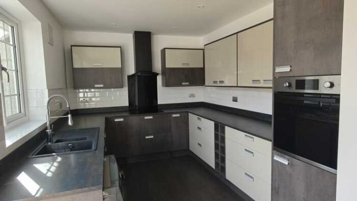 Young Howdens Hockley Dark Stone and Cream Gloss Kitchen – Lamona Appliances – Laminate Worktops
