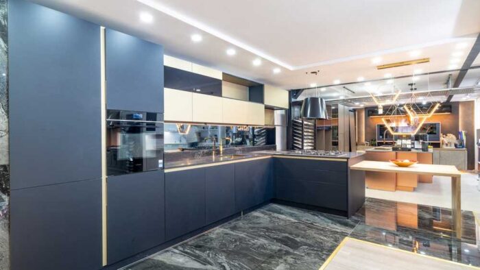 Ex Display Beeck Idealxt Anti Fingerprint Fenix Black Door with Gold Trim Kitchen with Peninsula and Dining Table – 1810 Appliances – Vanilla Noir Caesarstone Quartz Worktops