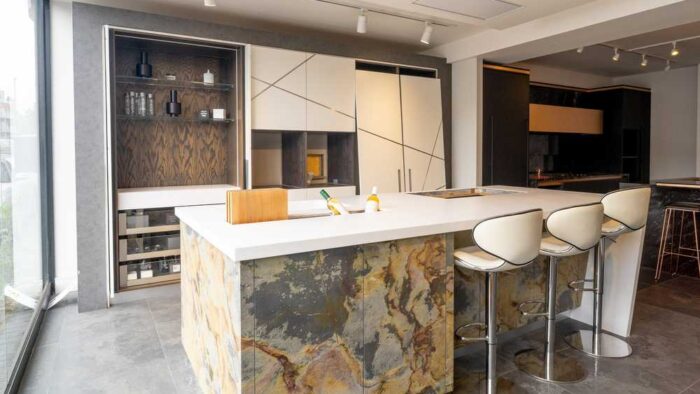 Ex Display The Wood Works Luxury Ascella Lacquered White with Aluminium Trim - Veneered Natural Slate Kitchen & Pocket Door Pantry with Matching Island & Wine Wall – Designer White Corian Worktops with Wine Trough