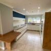 Modern Slab Cream Kitchen with Wooden Breakfast Bar – Neff Samsung Elica Appliances – Granite Worktops