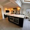 SieMatic Modern Slab Ivory Gloss Kitchen Breakfast Bar and Island – Neff Appliances – Corian Worktops