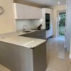 Poggenpohl Modern Slab Dove Grey & Cream Kitchen with Peninsula – Siemens Appliances – Quartz Worktops