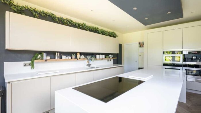 SieMatic Modern Slab Stone Light Cream Kitchen with Matching Island with Waterfall Sides – Miele Appliances – Glacier White Quartz Worktops