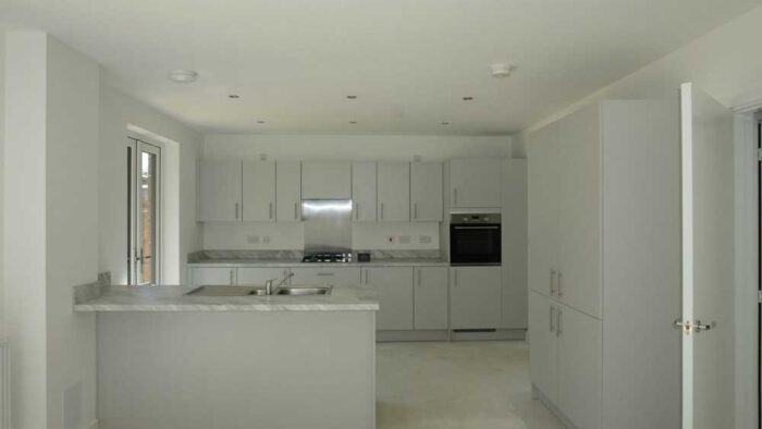 Unused Young Symphony Dove Grey Modern Slab Kitchen with Peninsula and Utility Room – Electrolux Appliances – Laminate Worktops