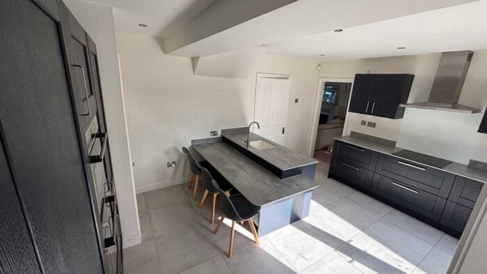 Young Blue Shaker Kitchen with Peninsula and Utility Room - Bosch Appliances – Dekton Worktops