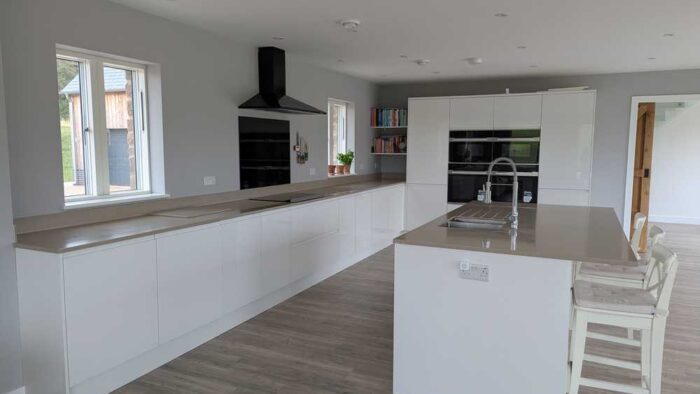 Young Howdens White Gloss J Handled Soft Close Kitchen with Matching Island – Lamona Appliances – Laminate Worktops