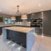 Graphite Grey Modern Slab Kitchen and Matching Island with Breakfast Bar – AEG Caple Appliances – Granite Worktops