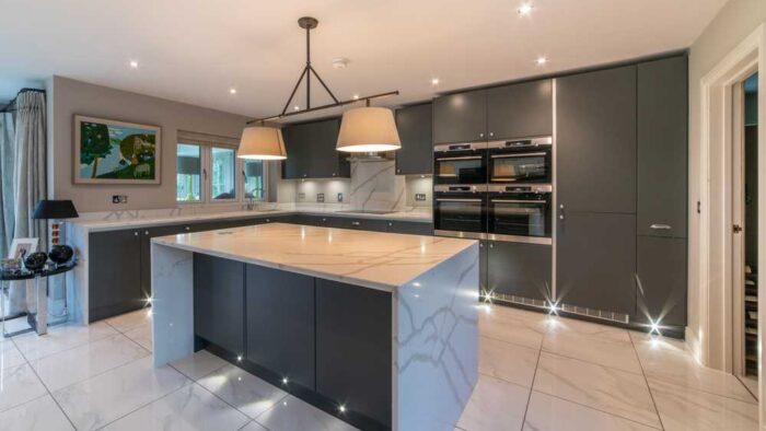 Graphite Grey Modern Slab Kitchen and Matching Island with Breakfast Bar – AEG Caple Appliances – Granite Worktops