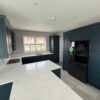 Young Blue Shaker Kitchen with Peninsula and Breakfast Table – Candy LG Appliances – Quartz Worktops